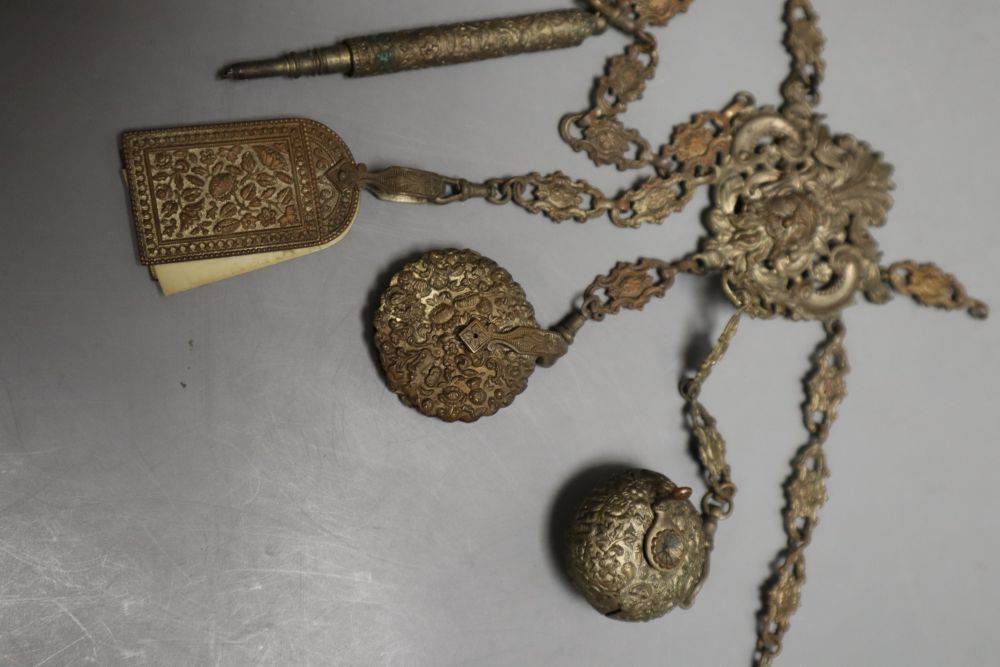 A Victorian embossed metal chatelaine, with seven attached domestic accessories, height 36cm